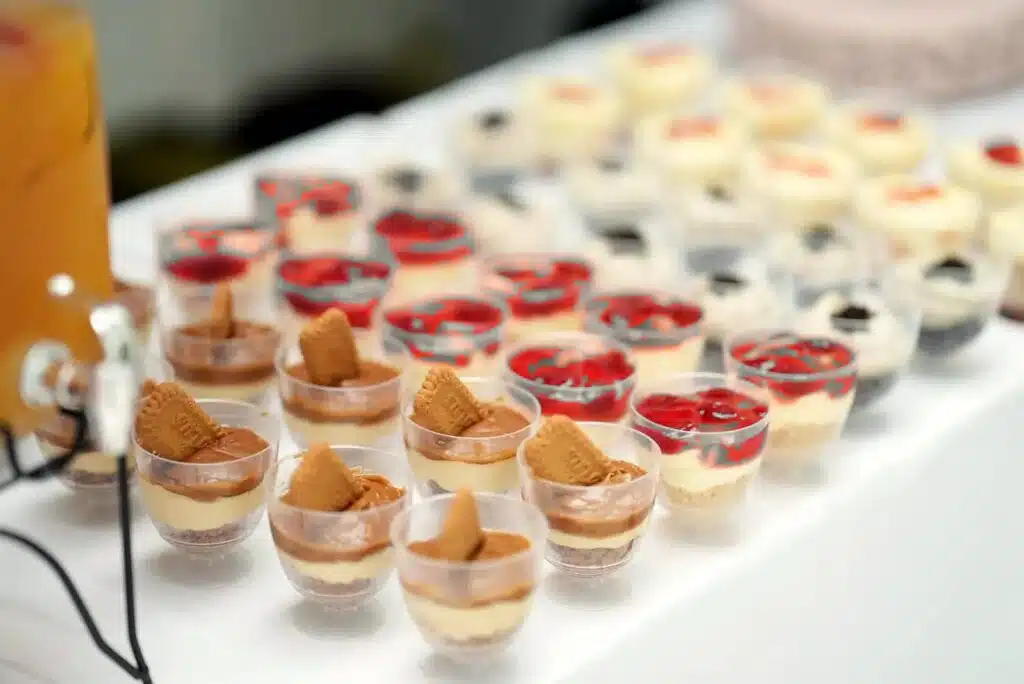 Rows of layered dessert cups on a white table
